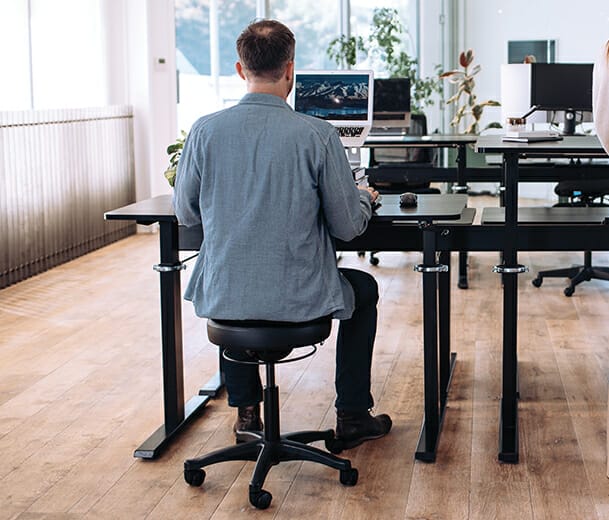 man sitting on buro polo stool in office