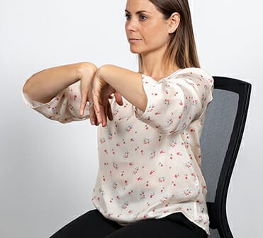 office wrist yoga stretch in desk chair