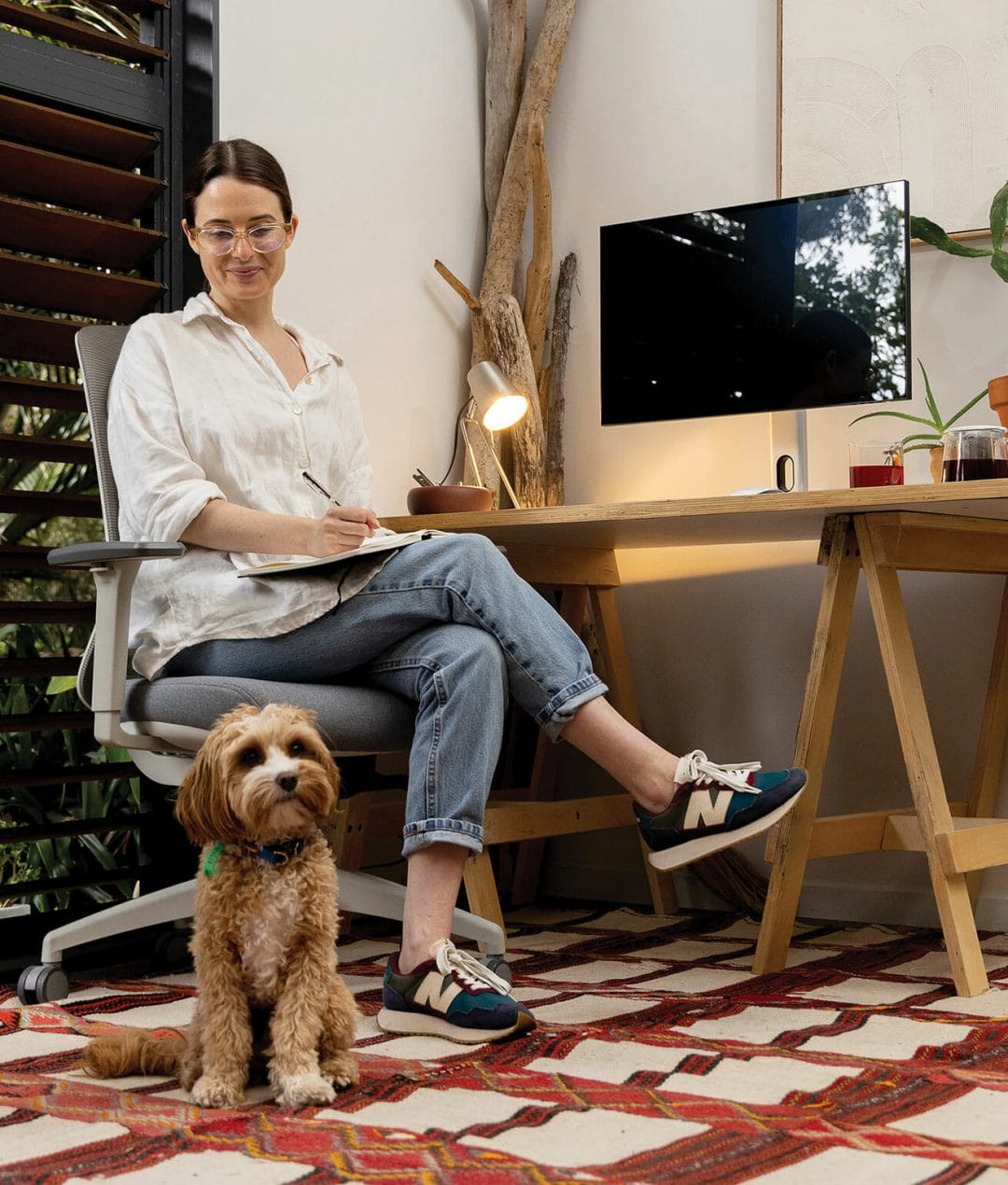 girl and dog working from home sitting on ergonomic chair 