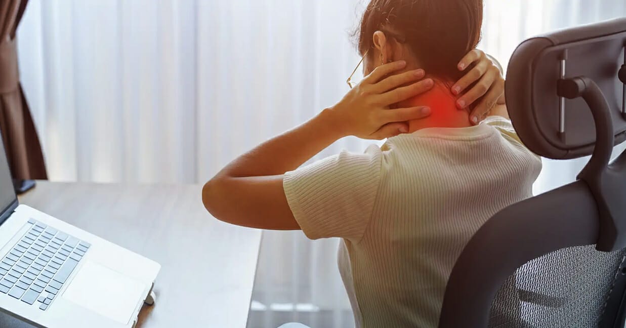 Woman suffering from neck pain due to poor work-from-home ergonomics