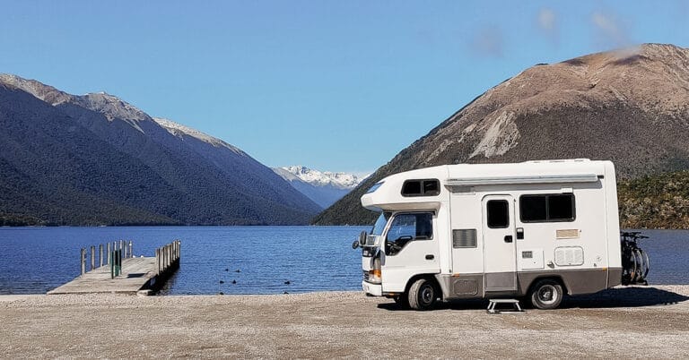van next to lake while travelling and working