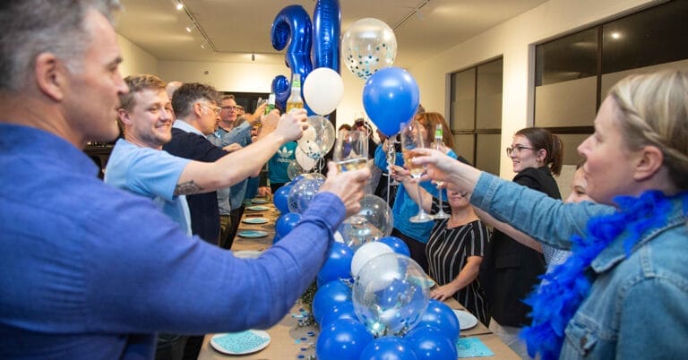 buro team toast to their 30th birthday dressed in blue