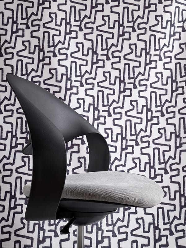 Konfurb Loop chair upholstered in Warwick Fabrics: Copeland Gull and background Easton Jet.